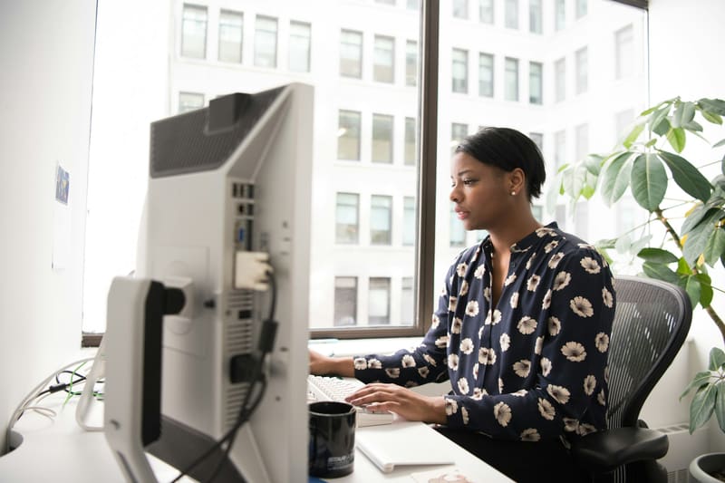 A woman typing at a desktop workstation — licensed illustration, not a person in the BLS count. Software developers.
